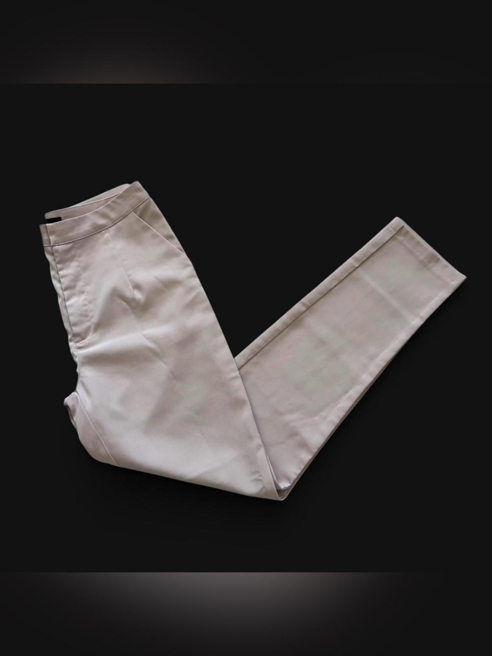 WOMAN pale pink satin trousers.